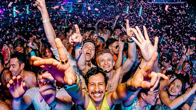 Partygoers throw their hands in the air during Dreamland NYE in Miami