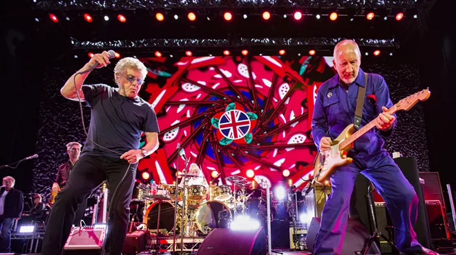 Two musicians are playing on stage.
