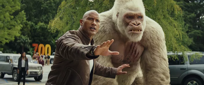 Image: Dwayne Johnson plays Davis, a misanthropic Special Forces soldier-turned-primatologist who trades solemn fist-bumps and sign-language dirty jokes with George, an ape that turns into a giant monster, in Rampage.