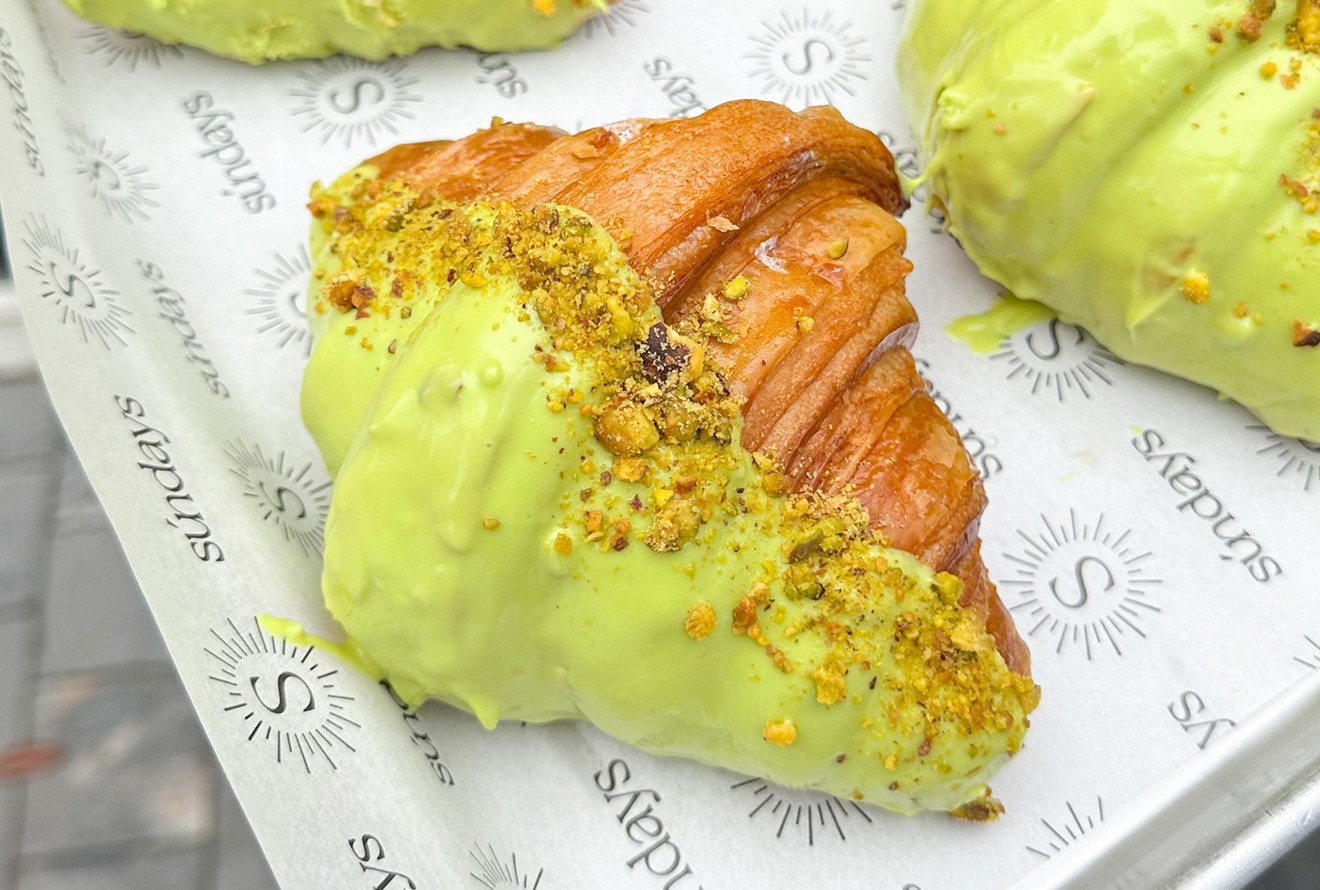The pistachio croissant from Sundays Croissanterie is covered in pistachio-flavored white chocolate and filled with pistachio cream.