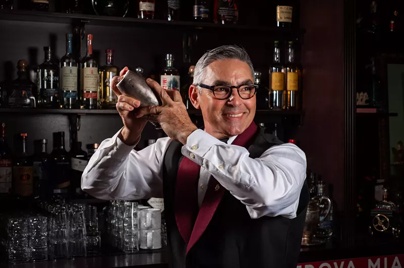 Image: A man making a cocktail