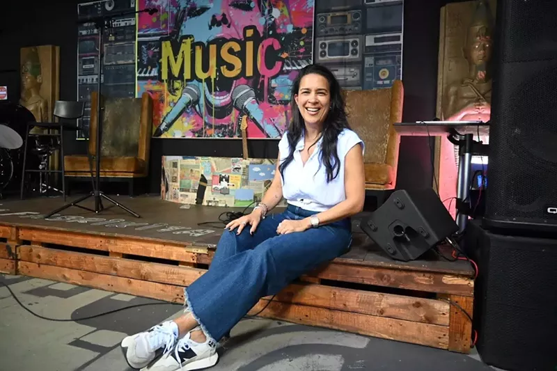Image: DJ Pati sitting inside La Fabrikita in Miami's Little Havana neighborhood