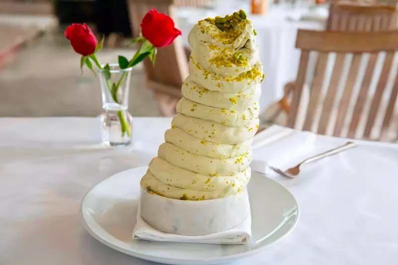Image: Prepared à la minute for each table, this luscious treat boasts a soft consistency and is made with pistachio sourced from Bronte, a small town in Sicily known for its exceptional nuts, often referred to as "green gold."