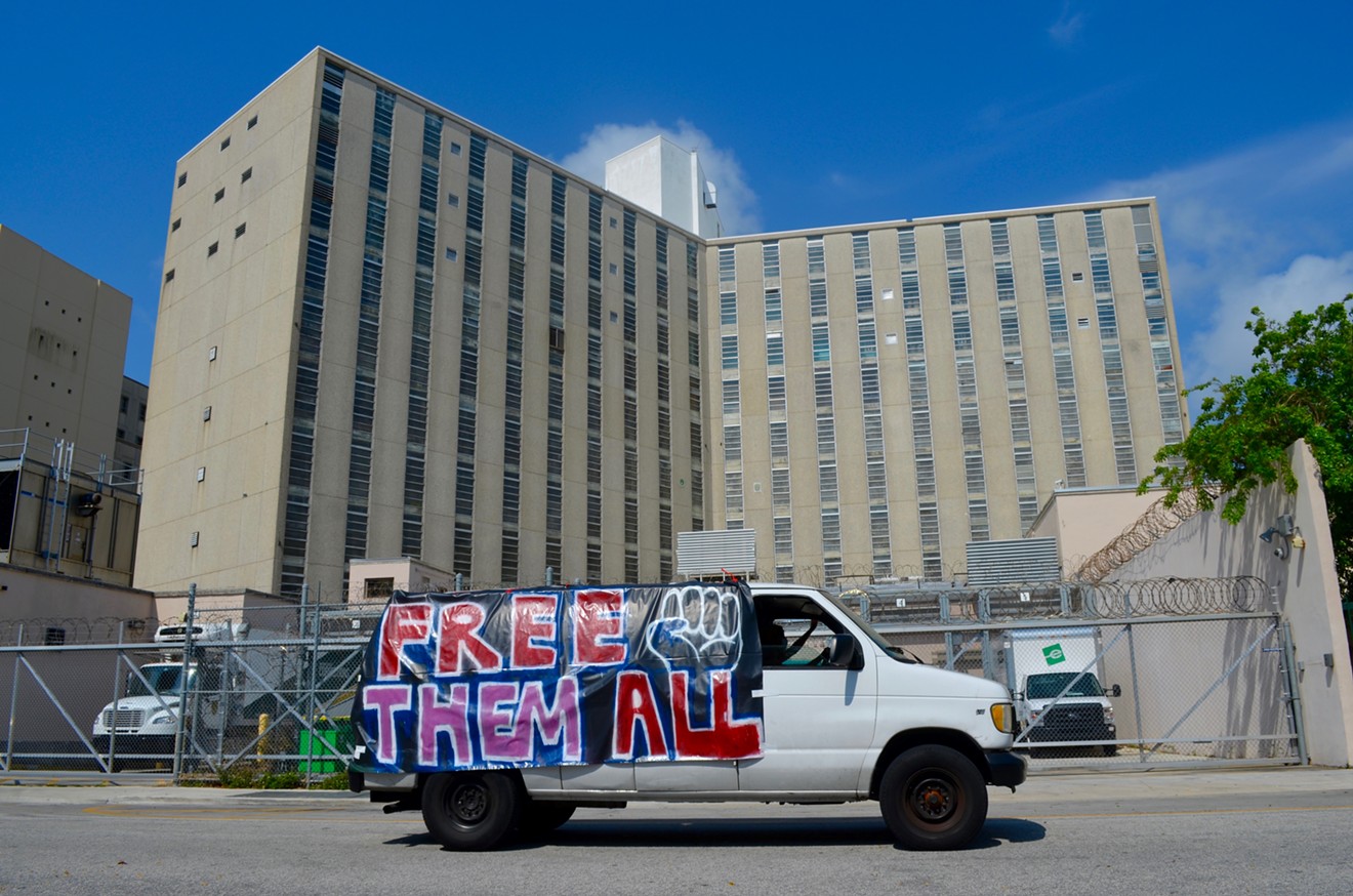 A protester drives around the Richard E. Gerstein Justice Building and pretrial detention center.