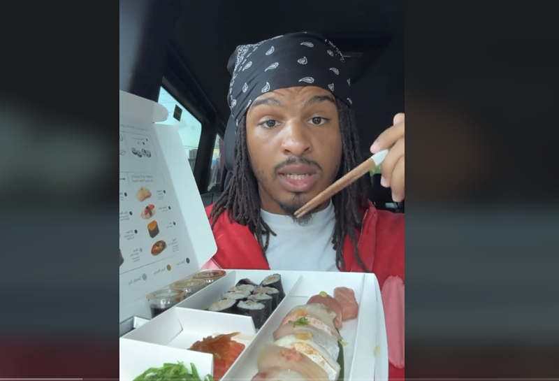 Image: a man happily eating sushi