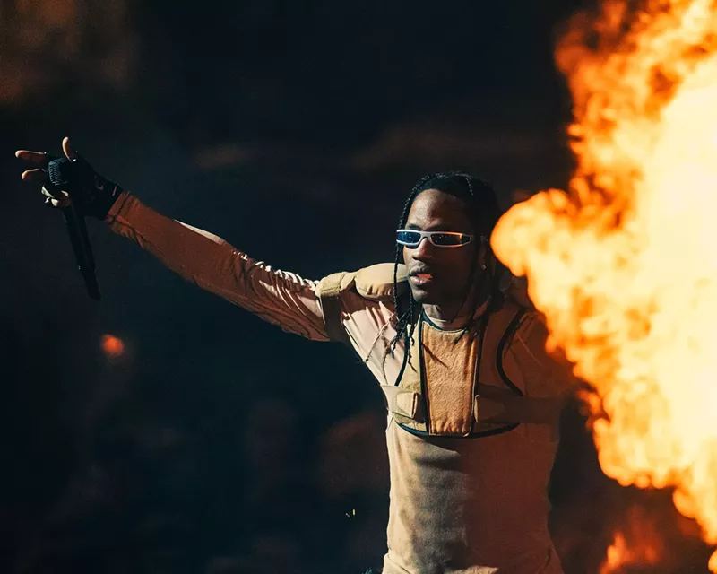 Image: Travis Scott performing at the Kaseya Center as pyrotechnics go off