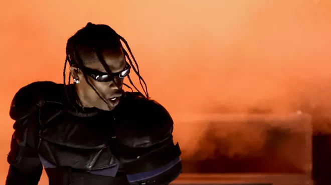 Rapper Travis Scott in sunglasses and armor-like clothing on stage at the Grammy Awards