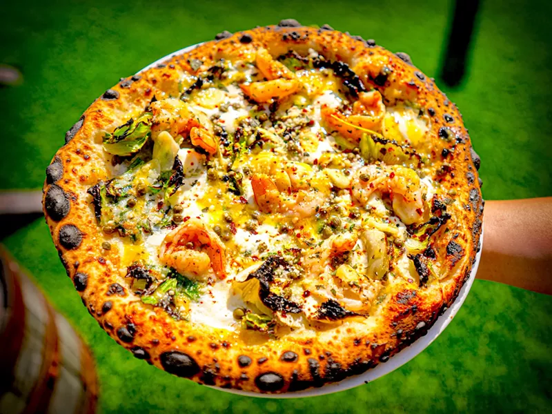 Image: The Diners, Drive-Ins, and Dives-featured Gulf shrimp pizza has become a permanent menu item at 3 Sons Brewing Co. in Dania Beach.