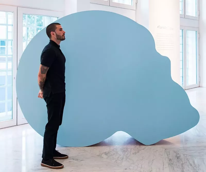 Image: Typoe stands next to one of his large-scale sculptures.