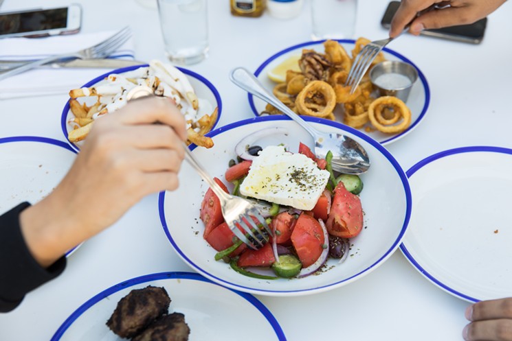 Greek village salad and fried calamari. - COURTESY OF MANDOLIN AEGEAN BISTRO