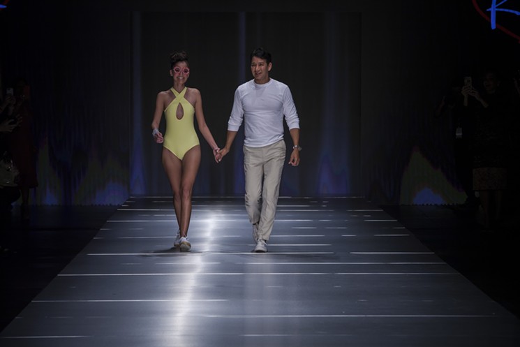 Rene Ruiz walks the runway alongside a model sporting one of his resort-wear looks. - COURTESY OF MIAMI FASHION WEEK