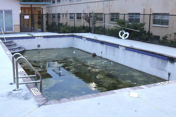 The locked and filthy swimming pool is an example of neglect, tenants say. - PHOTO BY MICHAEL CAMPINA