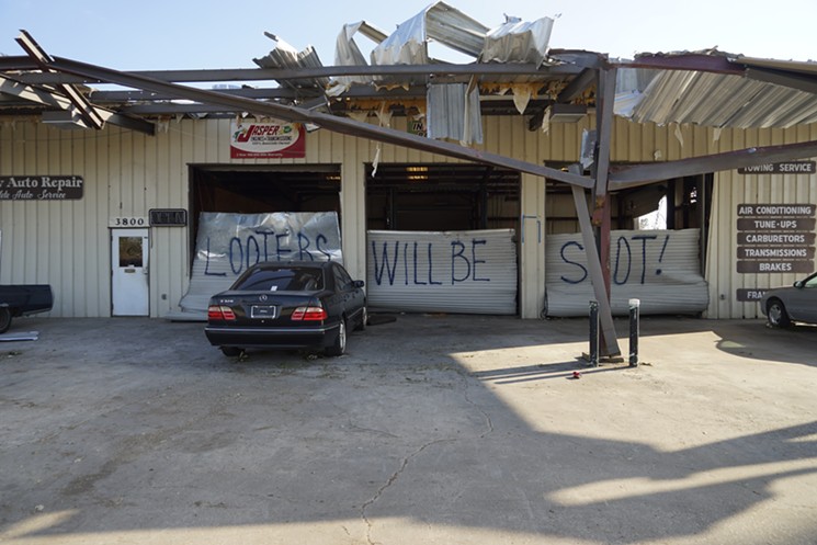 Public order in Panama City has taken a hit in the wake of Hurricane Michael. A damaged mechanic's shop in the Springfield neighborhood bears a grim and familiar warning. - MARIO ARIZA