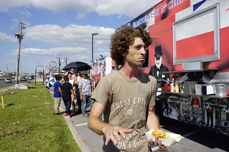 After waiting in line in the hot sun for a meal for himself and his family back home, Jonathan Williams, of Calloway, walks away with only a single serving. - ATENA SHERRY