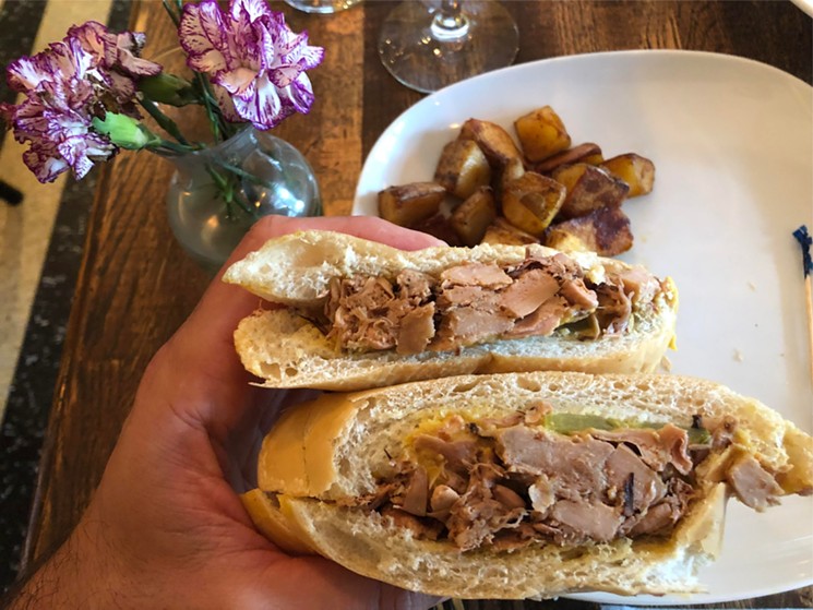 Jackfruit Cuban sandwich with jackfruit carnitas, pickles and melted queso on a Cuban bread. - FULL BLOOM VEGAN