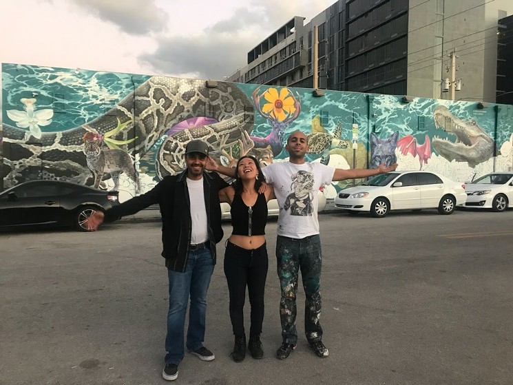 Juan Carlos Gallo, AR designer Linda Cheung, and Reinier Gamboa in front of the mural as it was still being painted - COURTESY OF LINDA CHEUNG