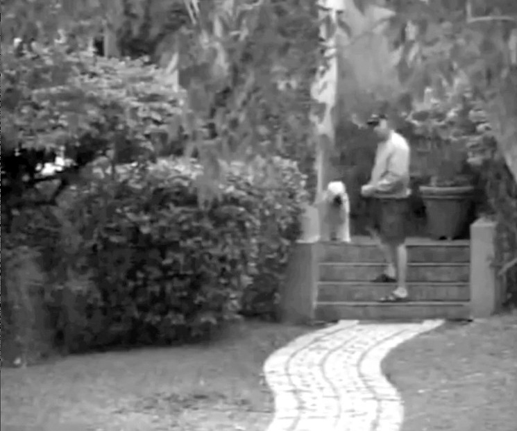 A still frame from Willy Alvarez's security camera the moment Cantor allegedly waved a gun at the Alvarez property. Cantor maintains he was making a gesture similar to casting a "spell." - MIAMI-DADE COURT RECORDS