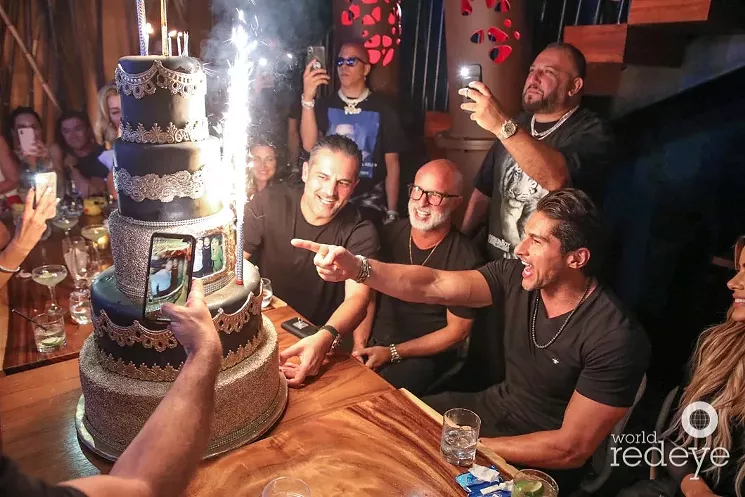Stanning Siegfried and Roy, David Einhorn (Papi) captures the cake with friends at Komodo. - WORLD RED EYE