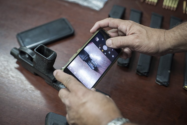 Handguns can be easily converted to fully automatic, a danger to citizens and to the officers trying to crack down on illegal weapons. - PHOTO BY DOUGLAS HOOK