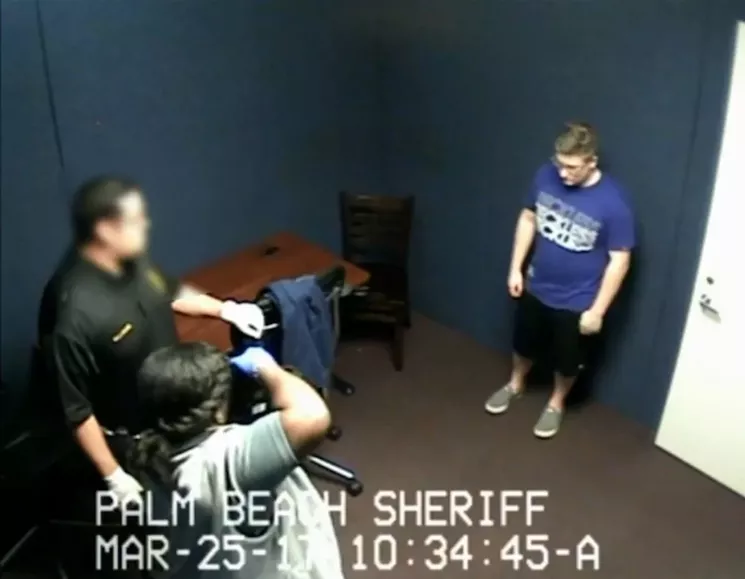 Investigators photograph Randy Herman Jr. shortly before his arrest. - SCREENSHOT VIA PALM BEACH COUNTY SHERIFF'S OFFICE
