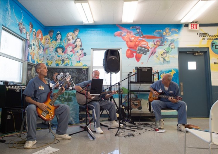 John Barrett (left) performing with other musicians in a Florida prison. - PHOTO COURTESY OF EXCHANGE FOR CHANGE