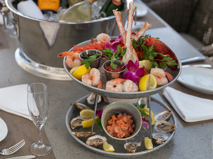 For a limited time, buy a bottle of Veuve Cliquot and get a free seafood tower at The Deck. - THE DECK AT ISLAND GARDENS
