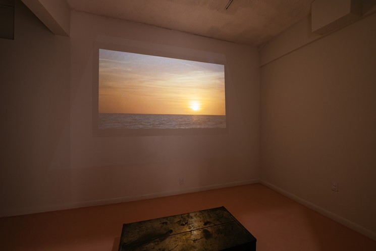 A video projection shows a Gulf Coast sunset, the sun inching below the horizon. - PHOTO COURTESY OF PEDRO WAZZAN