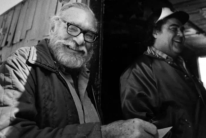 Les Hemingway distributes copies of his newspaper, The Bimini Out Island News, at End of the World Bar in Bimini in 2011. - COURTESY OF THE SOUTH FLORIDA SUN SENTINEL