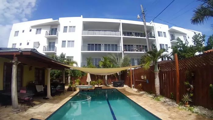 Maureen McCarthy had to install a canopy over her pool after a four-story apartment complex was built less than two feet from her property line. - PHOTO COURTESY OF DAVID WINKER