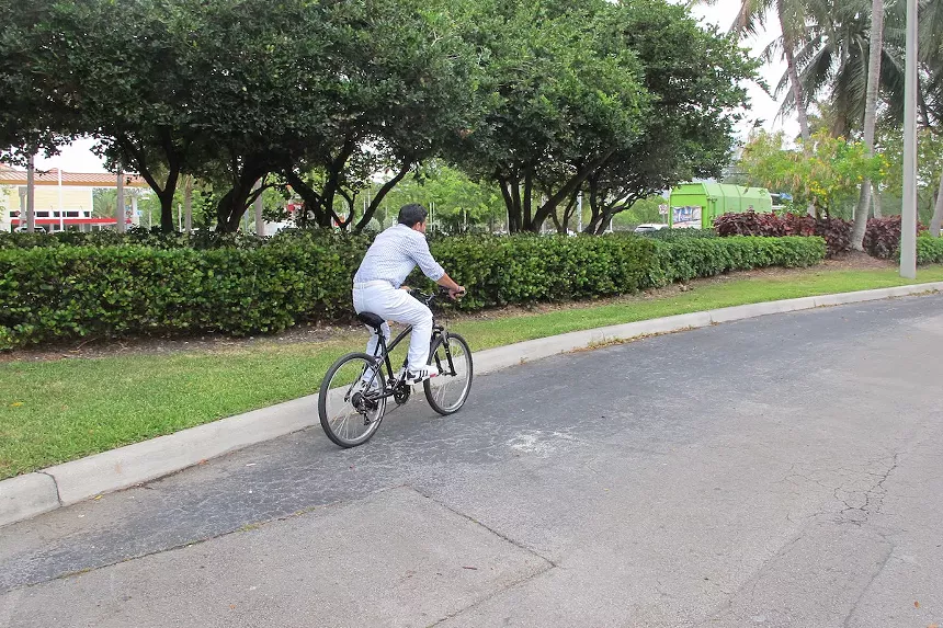 Hassani rides his bike most places to get around, with no car, license, or insurance to speak of. - PHOTO BY JOSHUA CEBALLOS