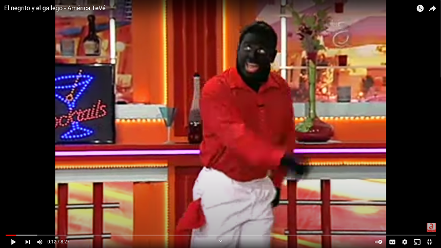 A clip from Carlucho's erstwhile comedy series El Negrito y El Gallego, in which he portrayed a white Spaniard (El Gallego) opposite a fellow white Cuban actor in blackface as El Negrito. - SCREENSHOT FROM AMÉRICA TEVÉ VIA YOUTUBE