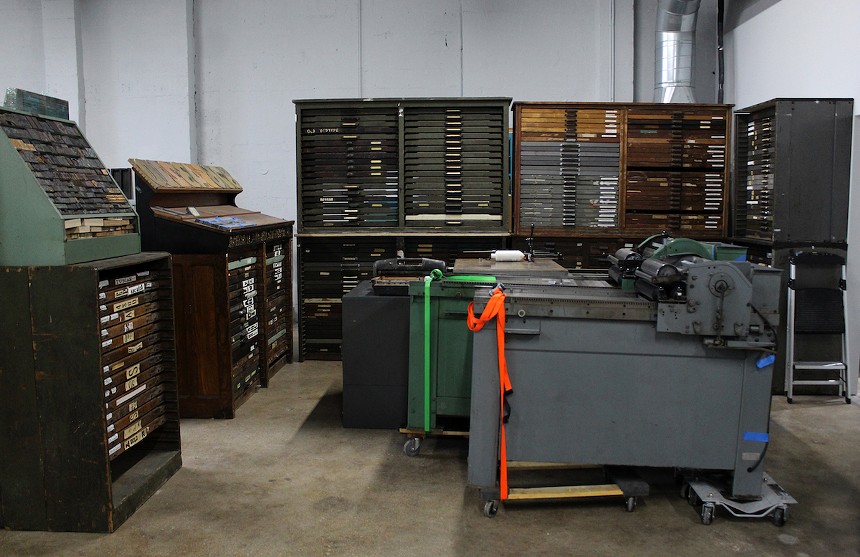 The letterpress room is separated by IS Project's massive collection of antique lead and wood types housed in antique type cabinets. - PHOTO BY JESSE FRAGA