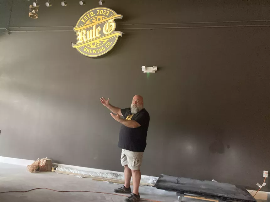 a man pointing at a sign