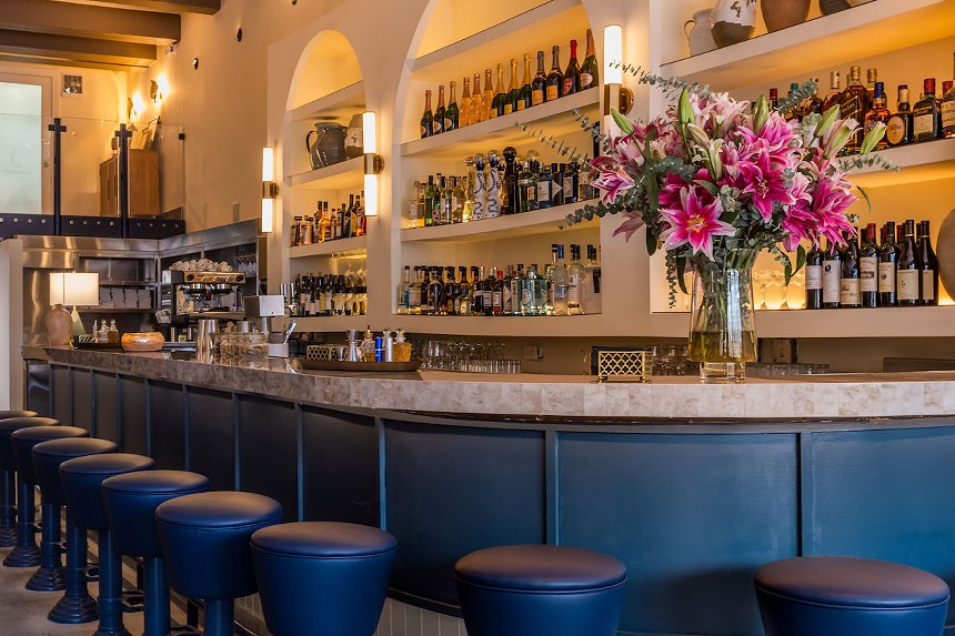 Issabella's bar has arched shelving and blue details