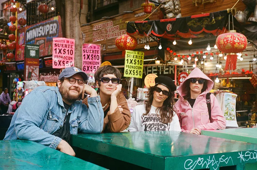 Alumine Soto, Ale Campos, Cuci Amador, and Emile Milgrim of Las Nubes sitting a green table