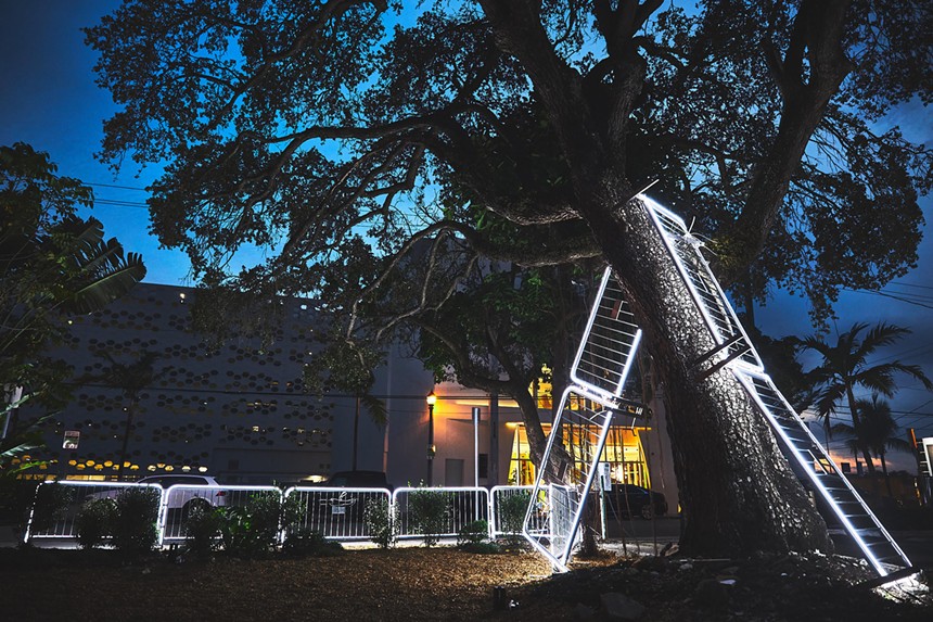 Antonia Wright and Ruben Millares' artwork features a metal barricades climbing over a tree