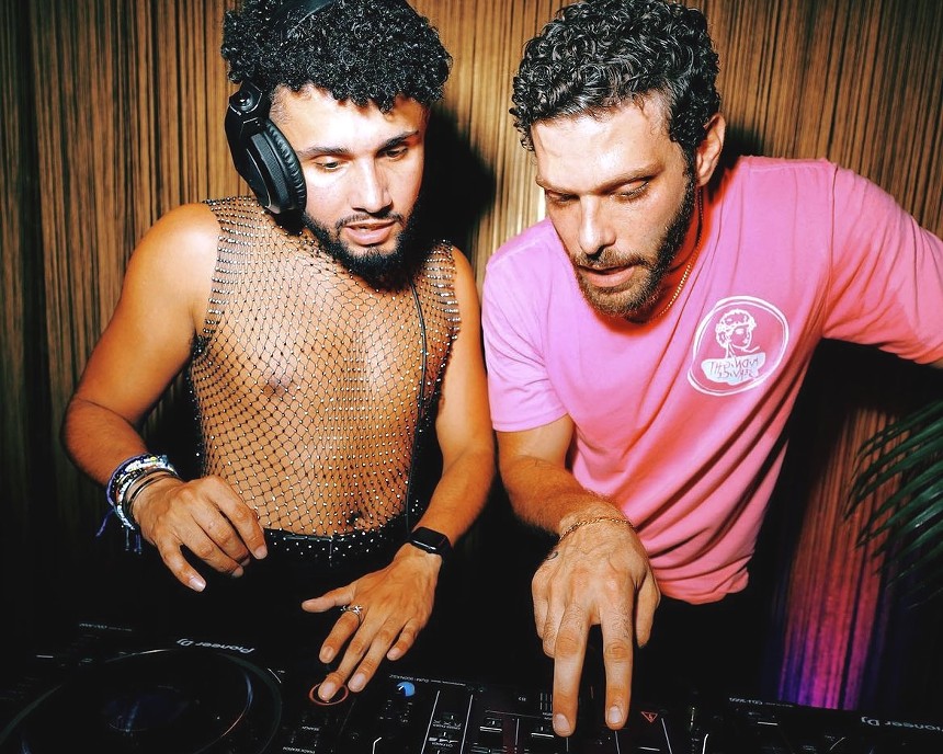 Midnight Service resident DJs Miguel Clark and Naim Zarzour hover over the decks