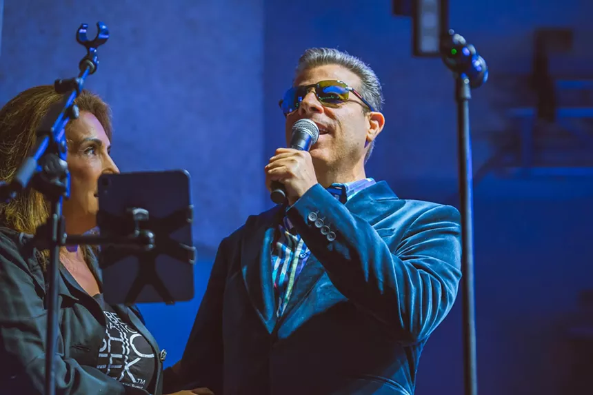 David New speaks on stage at the Miami Beach Bandshell