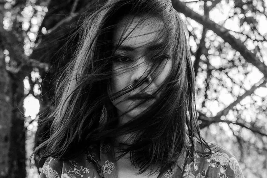 Mitski with her hair swept across her face
