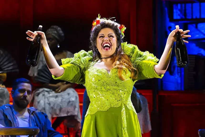 A castmember for Hadestown sings on stage