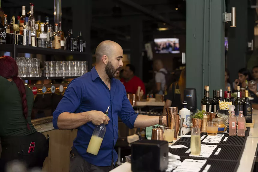 Biscayne Bay Brewing Company's master mixologist in a blue shirt