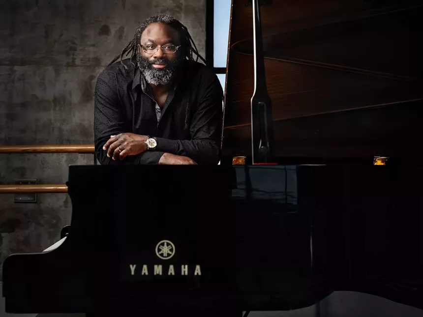 Awadagin Pratt leans on a piano