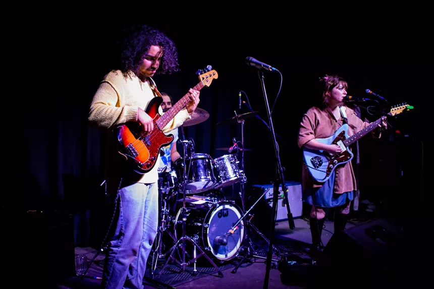 The members of Grim Hill performing on stage