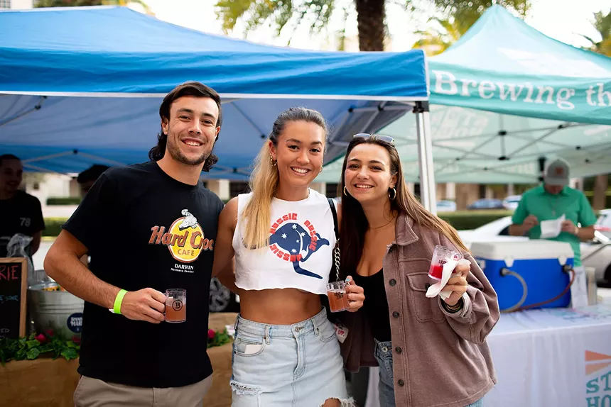people posing with a beer at Coral Gables