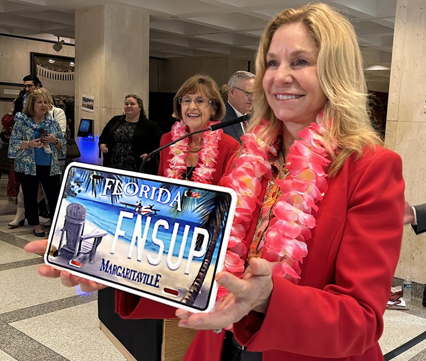 Rep. Linda Chaney holds a mock-up of the Margaritaville license plate