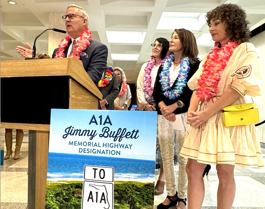 A podium with people celebrating the late Jimmy Buffett
