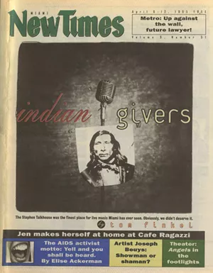 A tabloid newspaper cover showing an old-style stand microphone from which hangs an archival photo of a Native American