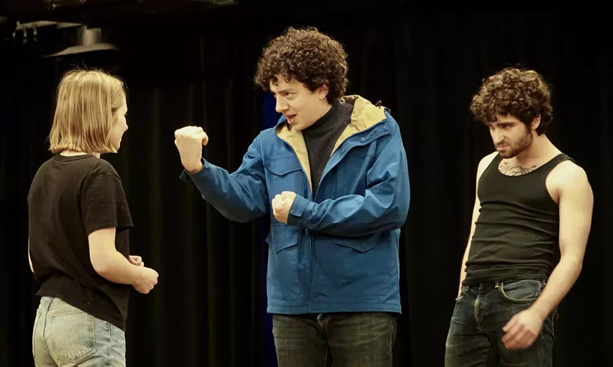 Director Giancarlo Rodaz instructing cast members Hallie Walker and Luke Surretsky during a rehearsal