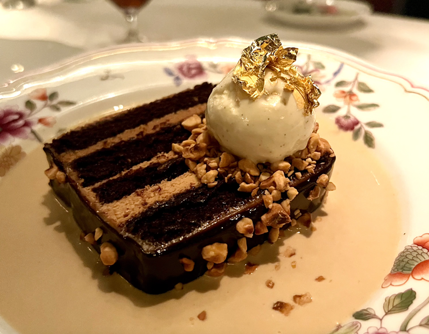 A chocolate cake with a dollop of cream on a plate