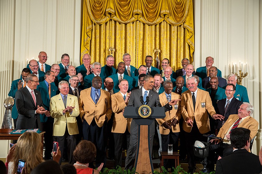 President Barack Obama honors retired players who were on the Miami Dolphins roster during the team's 1972 perfect season.